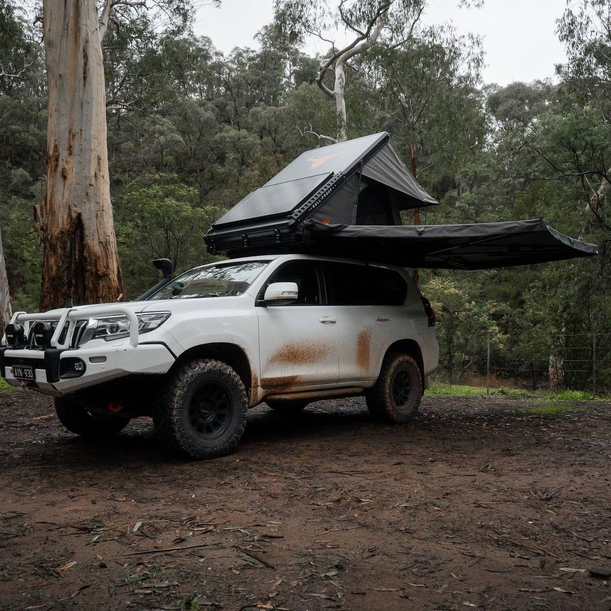 Iron Element 270 free standing awning deployed over a white Prado with a rooftop tent in the bush